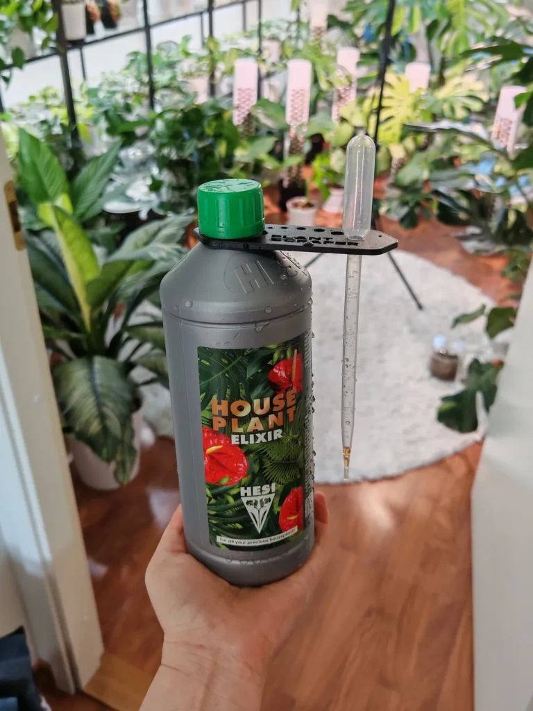 A bottle of HESI HousePlant Elixir in my hand